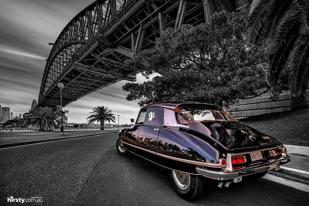 A classic Citroën DS parked beneath the Sydney Harbour Bridge, photographed by Richard Hirst